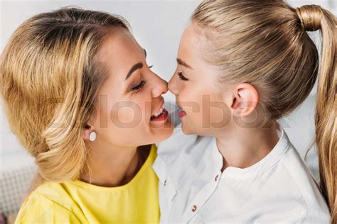 Close Up Shot Of Babe Cuddling Mother And Babe Touching Noses Stock Image Colourbox