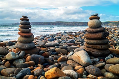 Low Angle Photography Of Two Piles Of Stones Near Seashore During