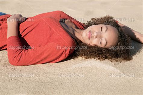 Girl Lying Down On Fine Golden Sand Stock Photo Mjth