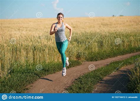 Woman Jogger Working Out In The Morning Sunny Day Stock Photo Image