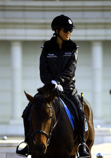 Dalians Mounted Policewoman In Full Leather Uniform Riding Helmets