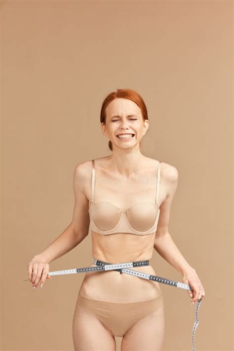 Skinny Suffering Female Model In Nude Underwear Tied Waist With