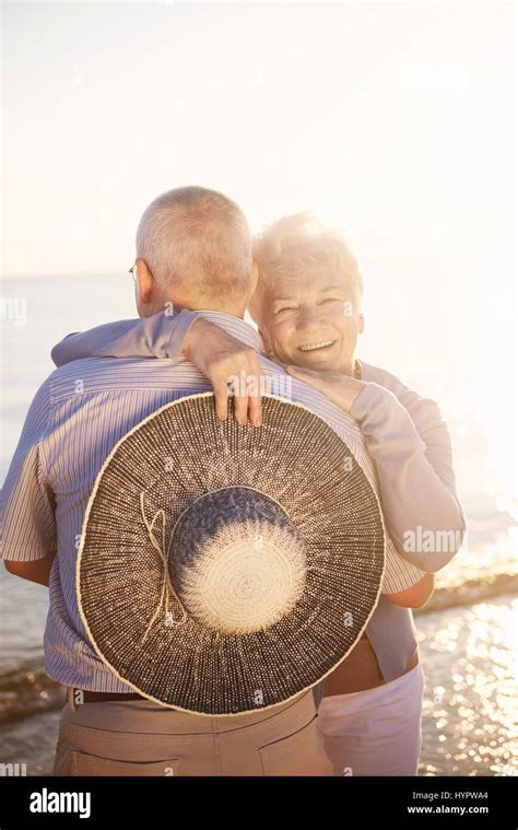Woman Hugging Her Senior Husband Stock Photo Alamy