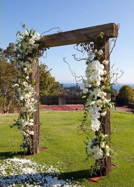 Picture Of Rustic Wooden Wedding Arch Decorated With White Flowers