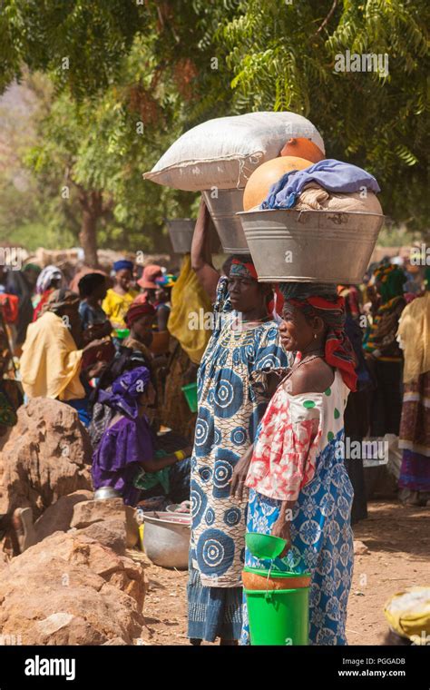 African Women Carrying Basins On Head In A Street Market Stock Photo