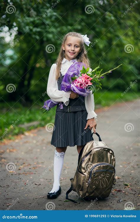Portrait Of Cute Adorable Little Caucasian School Girl Wearing Uniform