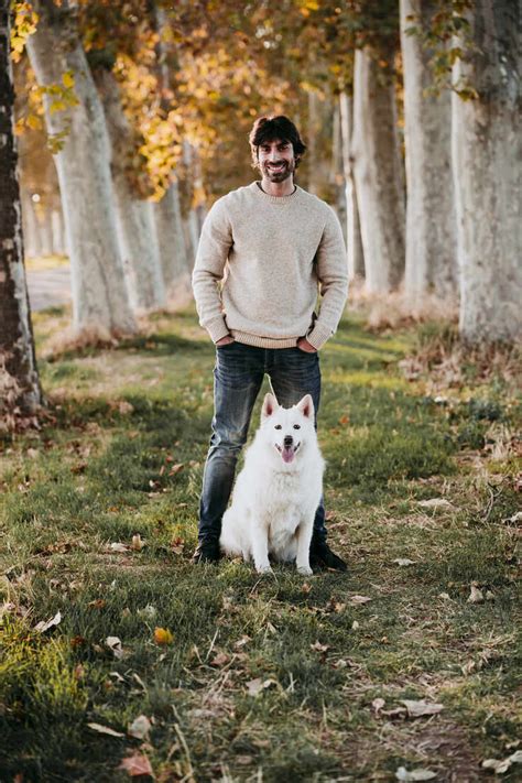 Man Standing With Dog At Forest Stock Photo
