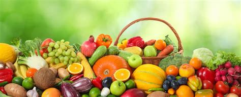 Assortment Of Fresh Organic Vegetables And Fruits On Blurred Green