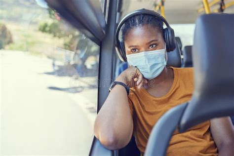 Travel Face Mask And Black Woman With Headphones On A Bus Driving To