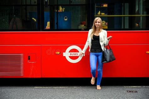 Trendy Young Woman At The Bus Stop To Catch A Red Double Decker Bus In London England Editorial