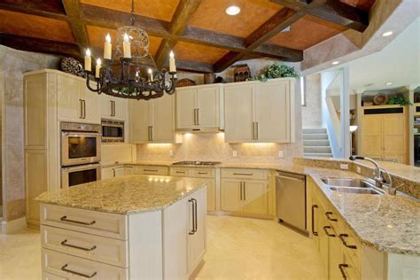 Mediterranean Kitchen With Cream Cabinets And Giallo Ornamental Granite