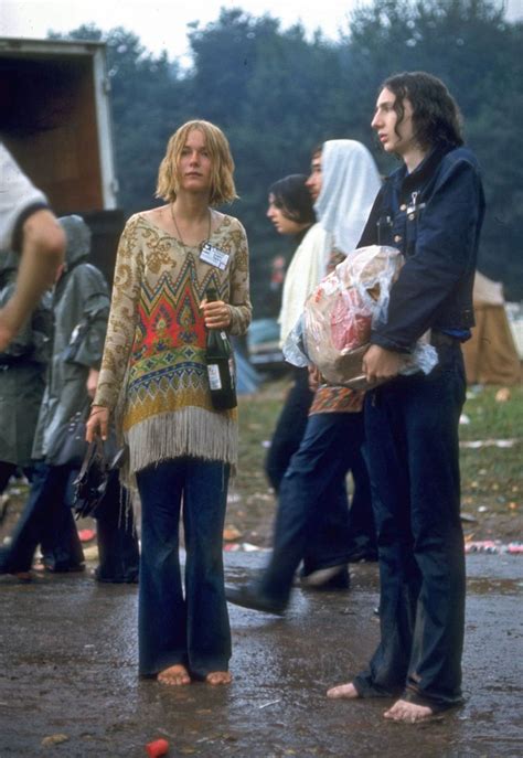 hippie couple standing barefoot on a road holding a bundle and wine bottle at woodstock bored panda