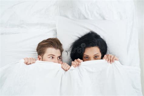 Young Couple Hiding Their Faces Behind Duvet Stock Photo Image Of