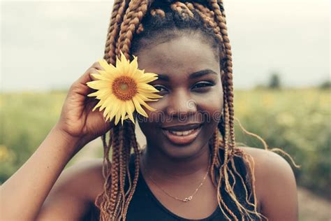 african american girl in a field of yellow flowers at sunset stock image image of american