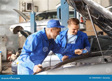 Male Mechanics Fixing Car In Service Center Stock Photo Image Of Shop