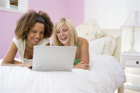 Teenage Girls Lying On Bed Using Laptop Stock Image Image Of Relaxing