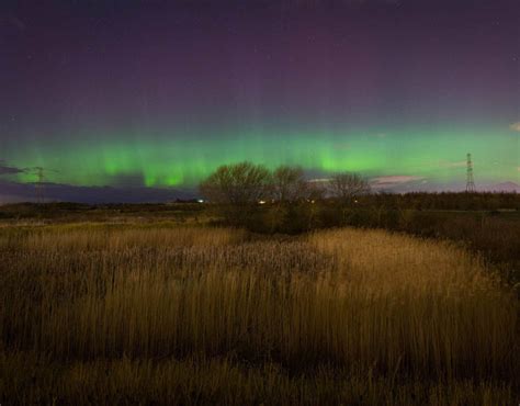 The Northern Lights Or Aurora Borealis Shine Over Great Park In