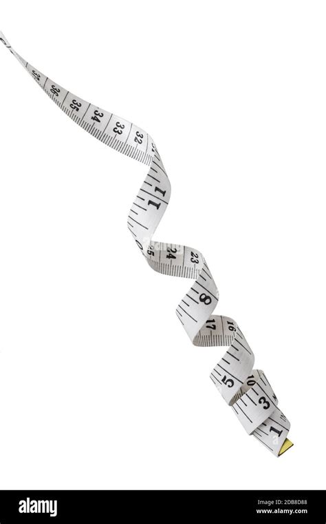 A Twisted White Tape Measure Showing Inches And Centimeters Stock Photo