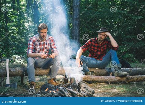 Company Two Male Friends Enjoy Relaxing Together In Forest Happy Young