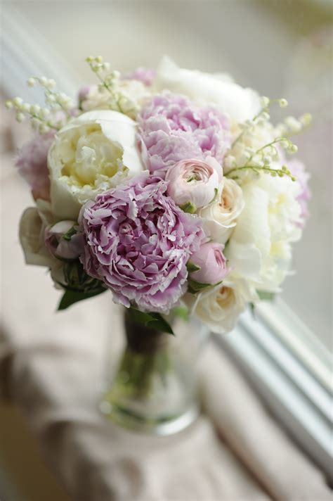 my wedding bouquet of peonies lily of the valley roses and ranunculus peony bridesmaid