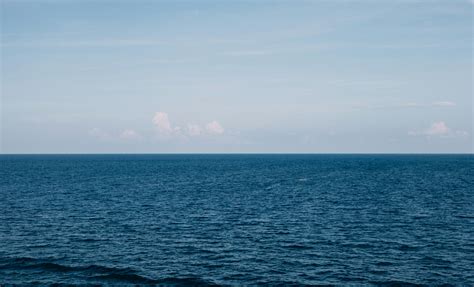 Blue Body Of Water Under White Clouds · Free Stock Photo
