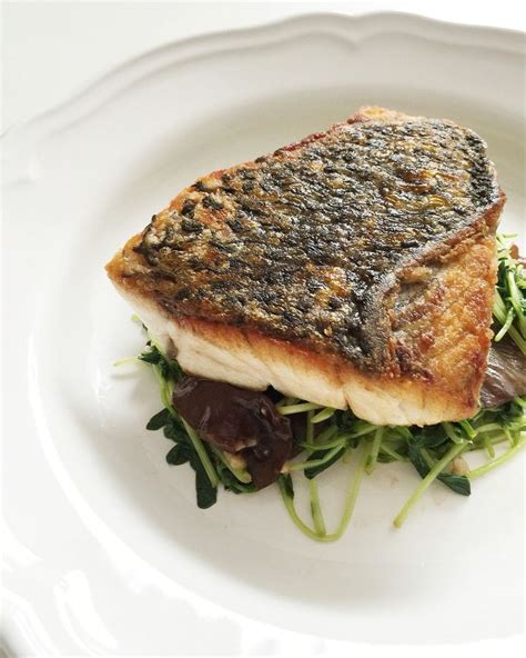 Pan Fried Barramundi With Crispy Skin Served With Saut Ed Pea Sprouts