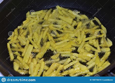 Frying French Fries In Sunflower Oil In A Frying Pan Stock Image