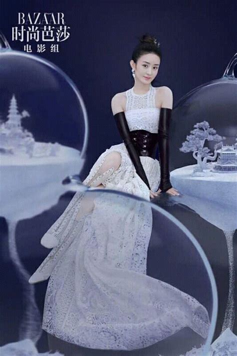 A Woman In White Dress And Black Gloves Sitting On Table With Snow