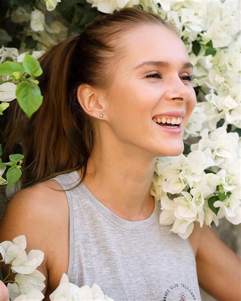 A Woman Smiling And Surrounded By White Flowers
