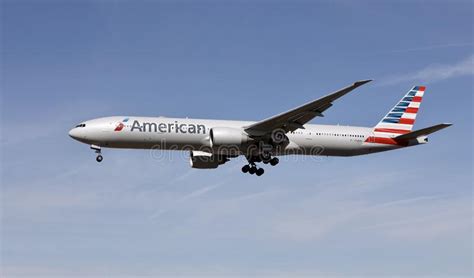 A Airplane Of American Airlines Flying In The Sky Editorial Image