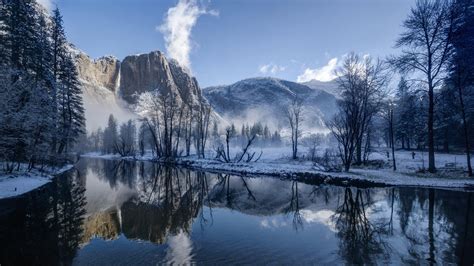 Landscape View Of Snow Covered Mountains Trees Reflection On River