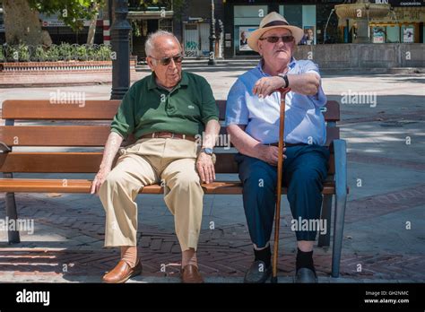 Dos Hombres Ancianos Sentados En Un Banco De Plaza Y Relajarse Durante