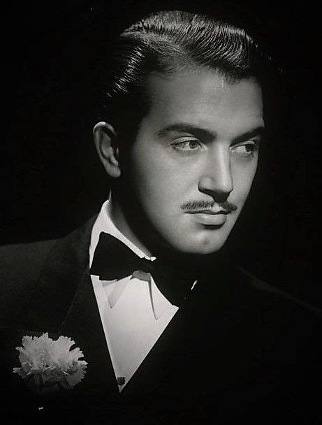 A Man Wearing A Tuxedo And A Flower In His Lapel