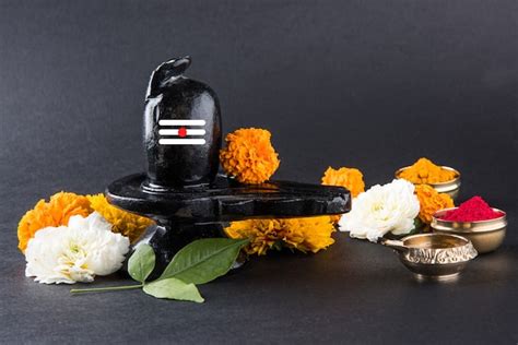 Premium Photo Shiva Linga Decorated With Flowers And Bel Patra Or Leaf
