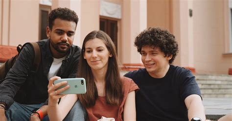 Three People Waving Their Hands While Taking Group Selfie · Free Stock