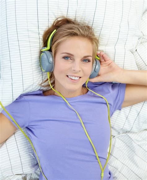 Blonde Woman Lying On Bed While Listening Music Stock Photo Image Of