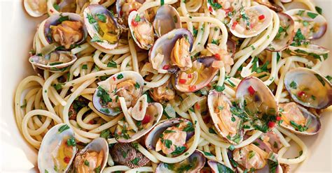 Lavare il prezzemolo, selezionarne le foglie e tritarle finemente con la mezzaluna su un tagliere assieme allo spicchio d'aglio spellato. Spaghetti Alle Vongole Bianco - The Happy Foodie