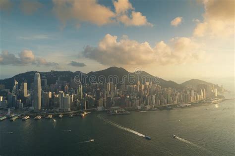Aerial View Of Hong Kong Skyline And Victoria Harbor During Suns Stock