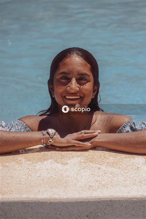 South Asian Woman In Blue Bikini Swimming In A Pool