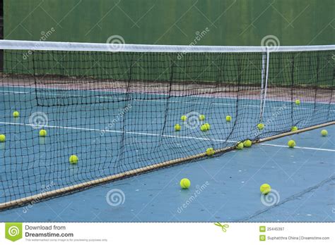 In the center of the court, you can see the tennis net stretched whose real height we are going to discuss in this article. Practice Tennis Balls On Court Royalty Free Stock ...