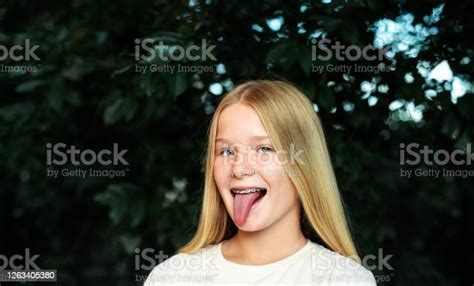 Teenage Girl With Orthodontic Braces Sticking Out Her Tongue Stock