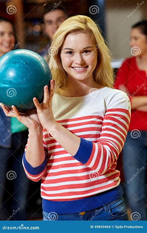 Happy Young Woman Holding Ball In Bowling Club Stock Photo Image Of