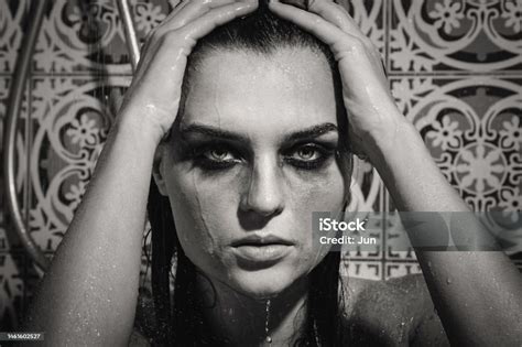 Sad And Wet Woman With Smudged Makeup On Her Face Under The Shower