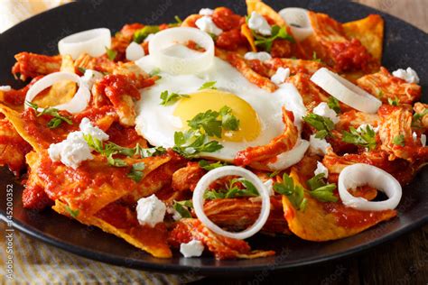Mexican Breakfast Chilaquiles With Egg And Chicken Close Up