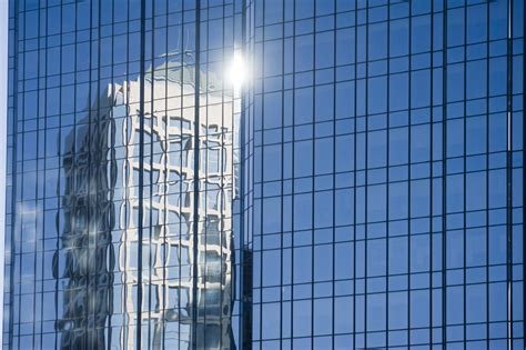 Free Image Of Building Reflected In The Facade Of A Skyscraper
