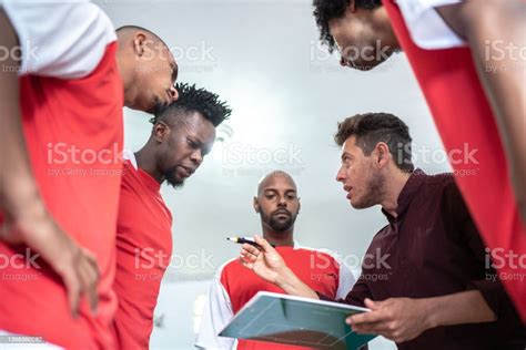 Soccer Coach Talking About Strategies With Soccer Players In The Locker