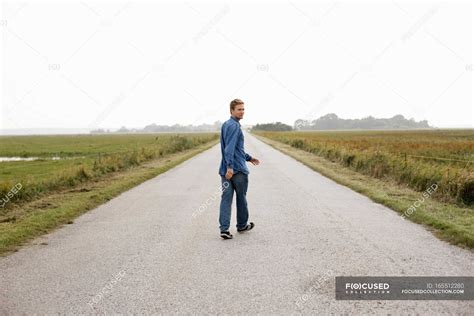 Man Walking On Rural Road — Adventure Turn Stock Photo 165512280
