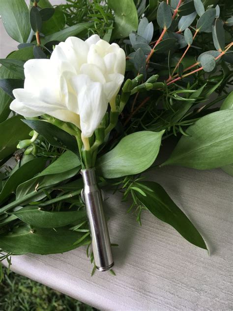 White Freesia Boutonniere In A Shell Casing Design By Colonial Florist
