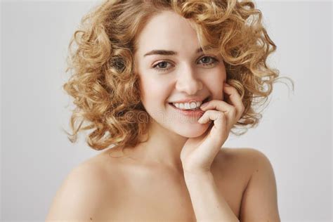 Waist Up Portrait Of Sensually Attractive European Woman With Short Curly Hair Biting Finger