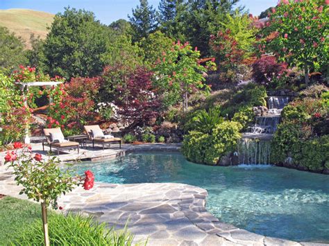 Our professional design staff is experienced in designing and installing patios, walks, walls, outdoor living areas, water features, fire pits, irrigation systems and outdoor lighting systems. Hillside landscape · Natural · Hillside Swimming Pool and ...